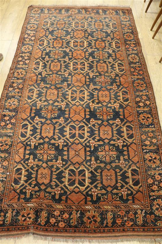 An Afghan red ground rug 235 x 125cm